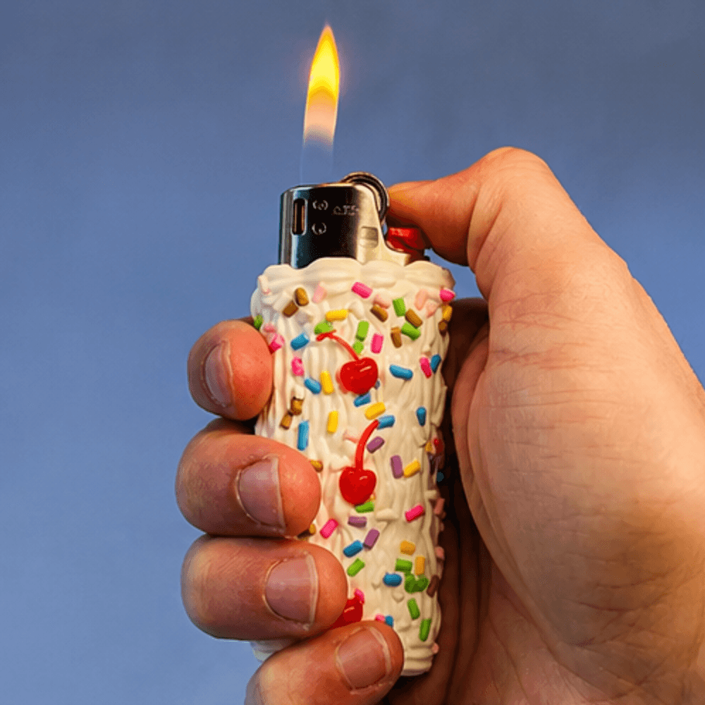The Cake Lighter, lit, held in a hand