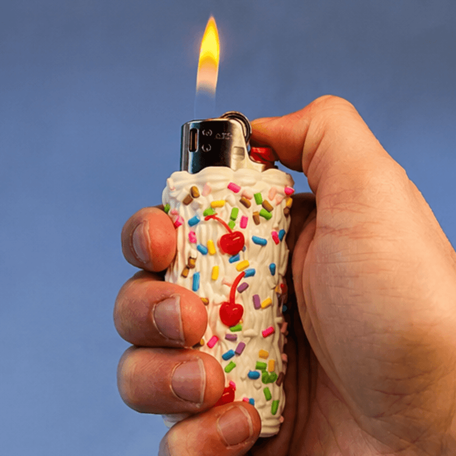 The Cake Lighter, lit, held in a hand